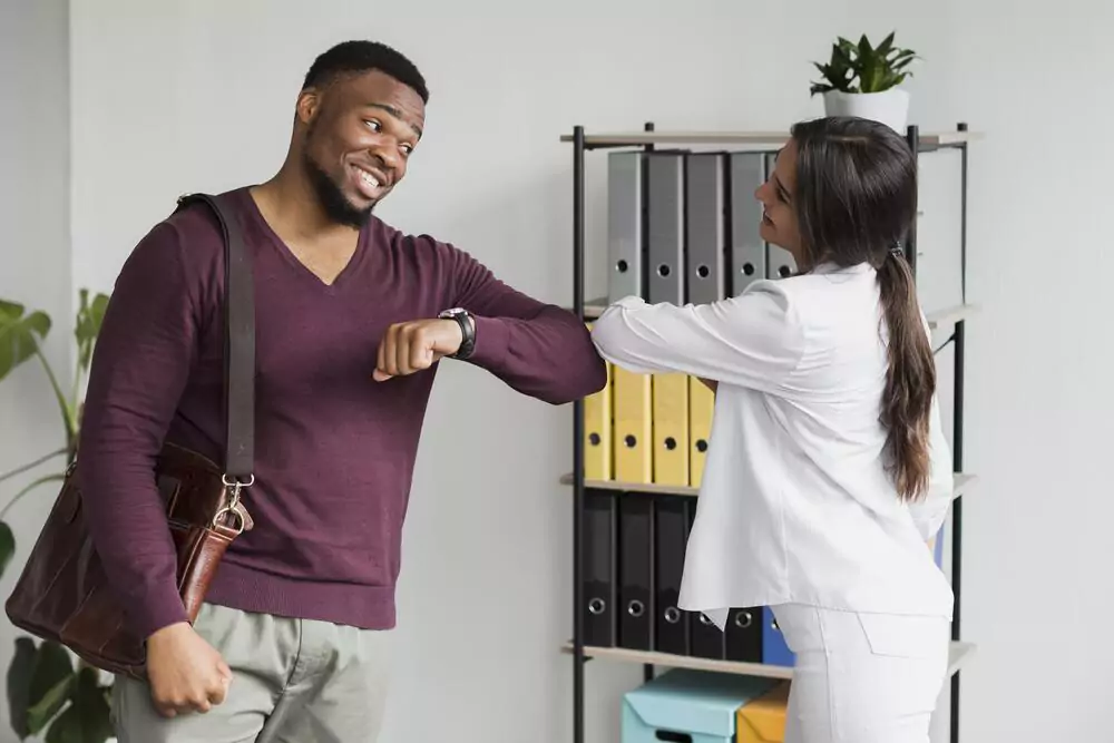 Coworkers Touching Elbows Work